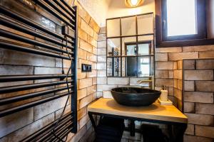 a bathroom with a black bowl sink on a wooden counter at Galaxy6189 Guesthouse in Tapolca +22 photos
