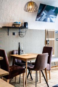 a dining room with a wooden table and chairs at Galaxy6189 Guesthouse in Tapolca