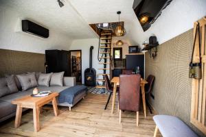 a living room with a couch and a table at Galaxy6189 Guesthouse in Tapolca
