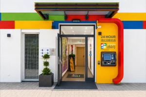 an entrance to a building with a vending machine at SHOME Hotel Graz I Self-Check-In I Free Parking in Graz +68 photos
