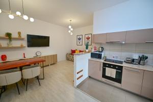a kitchen with a table and a counter top at FLH - Brukenthal Studios - Old Town in Sibiu