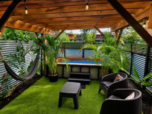 a patio with a hammock and chairs and a pool at Casita Don Marco in Bocas Town