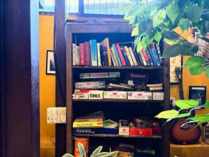 a book shelf filled with lots of books at Forrest Hostels in Mumbai