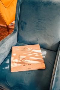 a book sitting on the seat of a chair at Garden Hotel Michelangelo in Mestre +54 photos