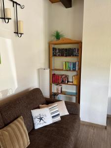 a living room with a couch and a book shelf at Ferienwohnung Raschke in Fehmarnsund +38 photos