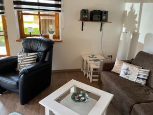 a living room with a couch and a table at Ferienwohnung Raschke in Fehmarnsund
