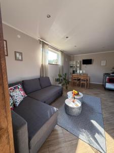 a living room with a couch and a table at Dom na wsi in Chmielno