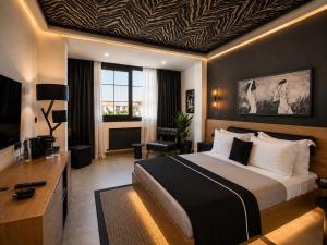 a hotel room with a large bed and a desk at The Local House Alaçatı in Alaçatı