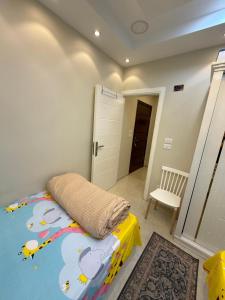 a bedroom with a bed with a winnie the pooh blanket at شقة فندقية غرفة واحدة in Mansoura