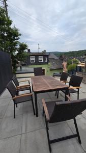 a wooden table and chairs on a patio at Ferienhaus am Alten Kloster in Lorch am Rhein
