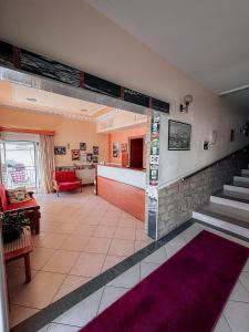 a large living room with stairs and a lobby at Hotel Ira in Leptokarya