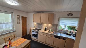 a kitchen with a sink and a stove at Ferienhaus am Alten Kloster in Lorch am Rhein