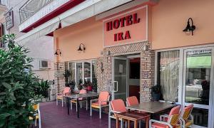 a hotel with tables and chairs outside of a restaurant at Hotel Ira in Leptokarya