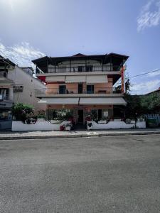 a building on the side of a road with a street at Hotel Ira in Leptokarya +8 photos