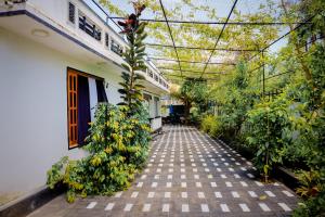 a hallway of a house with a greenhouse and plants at TJ Signature Spaces in Point Pedro
