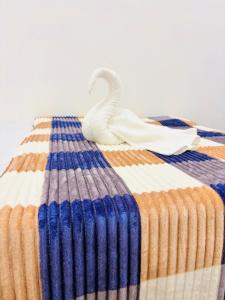 a swan toy sitting on top of a bed at TJ Signature Spaces in Point Pedro +3 photos