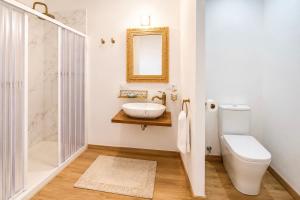 a bathroom with a sink and a toilet and a mirror at Hostal playa Dreams náutico Adults in Garrucha