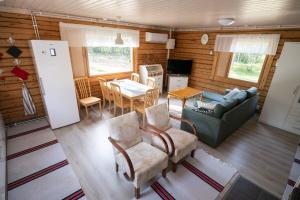 a living room with a couch and a table at Poromoision pirtti in Peurasuvanto