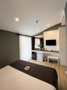 a bedroom with a bed and a desk with a television at Ber Mai İnci Hotel Antalya in Antalya +51 photos