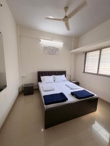 a bedroom with a large bed in a room at Swami Homestay in Solapur
