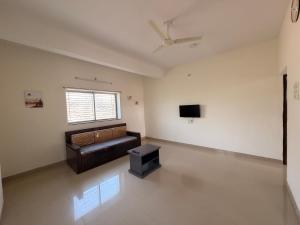 a living room with a couch and a tv at Swami Homestay in Solapur +23 photos