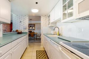 a kitchen with white cabinets and green counter tops at Sea Colony oceanfront 4th floor condo with elevator in Bethany Beach
