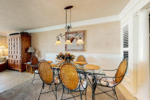a dining room with a glass table and chairs at Sea Colony oceanfront 4th floor condo with elevator in Bethany Beach