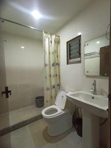 a bathroom with a toilet and a sink at Raj Garden Resort in Guwahati