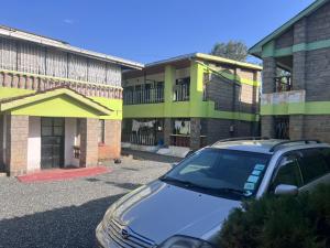 a car parked in a parking lot in front of a building at PODLYNS Home in Ngong +18 photos