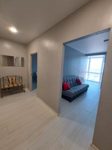 a living room with a blue couch in a room at Яровиця 9699 in Lutsk