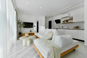 a white living room with white furniture and white walls at Sole Azzurro Villas in Kanali
