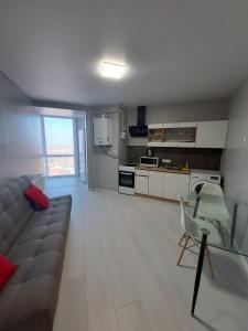 a living room with a couch and a kitchen at Яровиця 9699 in Lutsk