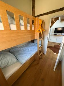 a bunk bedded room with a bunk bed in a house at FiO Ferienhäuser - Ferien in Ohne in Ohne