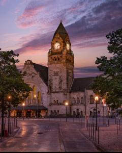 a large building with a clock tower at night at La terrasse du palais in Metz
