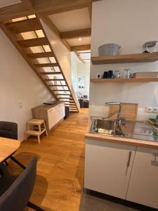 a kitchen with a sink and a wooden floor at FiO Ferienhäuser - Ferien in Ohne in Ohne