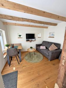 a living room with a couch and a table at FiO Ferienhäuser - Ferien in Ohne in Ohne