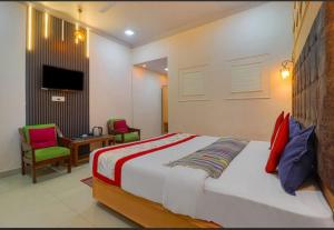 a bedroom with a bed and a table and chairs at Hotel Amar in Mussoorie