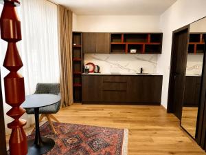 a living room with a table and a kitchen at Design-Apartment Siegen Oberstadt in Siegen