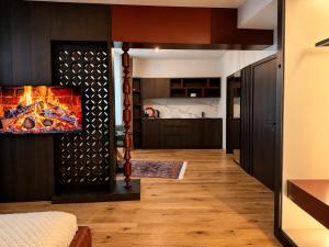 a kitchen with a fireplace in a living room at Design-Apartment Siegen Oberstadt in Siegen