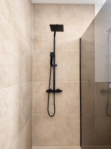 a shower with a shower head in a bathroom at Design-Apartment Siegen Oberstadt in Siegen