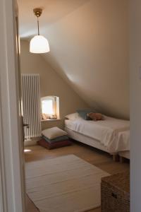a attic room with a bed and a mirror at JETHON Appartement am Wasserturm 1 in Nienburg