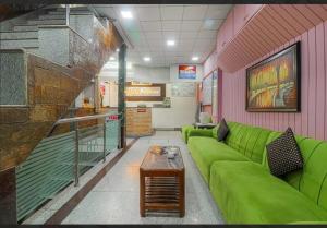 a living room with a green couch in a store at Hotel Amar in Mussoorie +31 photos