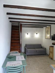 a living room with a couch and a table at Maison Milani Centuri in Centuri