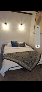 a bedroom with a bed with a blanket on it at Maison Milani Centuri in Centuri
