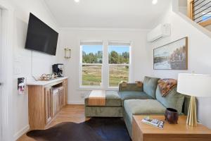 a living room with a couch and a table at Huckleberry Inn in Custer