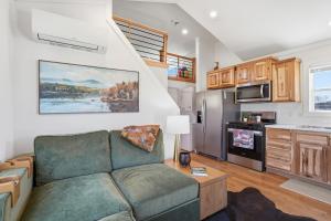 a living room with a couch and a kitchen at Huckleberry Inn in Custer