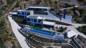 an aerial view of a house with a swimming pool at The Cliff Residences in Plomari
