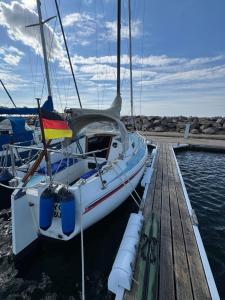 a sailboat is docked at a dock at Schlafplatz mit Meerblick in Kühlungsborn +17 photos