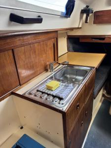 a kitchen with a sink in the middle at Schlafplatz mit Meerblick in Kühlungsborn