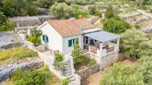 an aerial view of a small white house with a roof at House Vers in Vela Luka